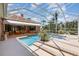 Stunning screened-in pool with spa and covered patio, surrounded by lush landscaping and a beautifully maintained backyard at 7303 Westminster Ct, University Park, FL 34201