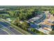 Scenic aerial view of a residential community nestled near a golf course, road, and lush greenery at 7519 Berna Ln, Land O Lakes, FL 34637