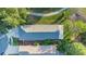 Birds eye view of home's roof, landscaping, driveway and nearby green space at 7519 Berna Ln, Land O Lakes, FL 34637