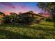 Spacious backyard with screened-in patio perfect for outdoor enjoyment, landscaping, and lawn at 7519 Berna Ln, Land O Lakes, FL 34637