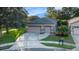 Charming single-story home with a two-car garage, driveway, and manicured lawn at 7519 Berna Ln, Land O Lakes, FL 34637
