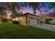 Three-car garage with a concrete driveway and lush green lawn offers ample parking and curb appeal at 7519 Berna Ln, Land O Lakes, FL 34637