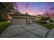 Three-car garage with a concrete driveway and manicured lawn offers ample parking and curb appeal at 7519 Berna Ln, Land O Lakes, FL 34637
