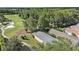 Picturesque golf course featuring mature trees and winding water features by residential properties at 7519 Berna Ln, Land O Lakes, FL 34637
