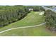 Scenic aerial view of the golf course, landscaping and nearby highway at 7519 Berna Ln, Land O Lakes, FL 34637