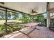 An outdoor patio with brick flooring features a hammock, plants, and a ceiling fan at 7519 Berna Ln, Land O Lakes, FL 34637