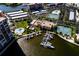 Aerial view showcasing the community's amenities including a marina, tennis courts, swimming pool, and parking at 7700 Sun Island S Dr # 506, South Pasadena, FL 33707
