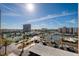 Bright community view showing tennis courts, parking, a high-rise condo building and the surrounding area at 7700 Sun Island S Dr # 506, South Pasadena, FL 33707