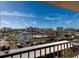 Community view from balcony showcasing tennis courts, pool, parking, and surrounding condo buildings at 7700 Sun Island S Dr # 506, South Pasadena, FL 33707