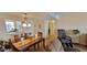Dining room with wood table set for six, view into the kitchen, and tile floor at 7700 Sun Island S Dr # 506, South Pasadena, FL 33707
