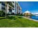 Beautiful building exterior with lush landscaping and waterfront views in a serene and inviting community at 7700 Sun Island S Dr # 506, South Pasadena, FL 33707
