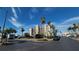 Exterior shot of condo building showing lush tropical landscaping, parking and blue sky at 7700 Sun Island S Dr # 506, South Pasadena, FL 33707