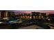 Scenic dusk view of condo buildings with a pool, parking area, palm trees, and lush landscaping at 7700 Sun Island S Dr # 506, South Pasadena, FL 33707