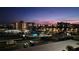 Community including the pool, residential buildings, parking, and palm trees at dusk at 7700 Sun Island S Dr # 506, South Pasadena, FL 33707