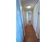 Hallway with multiple white storage closets and a view to the bathroom with shower at 7700 Sun Island S Dr # 506, South Pasadena, FL 33707