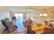 Open-concept living area with comfortable seating and access to a balcony with stunning views at 7700 Sun Island S Dr # 506, South Pasadena, FL 33707