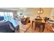 Cozy living room with an open layout to the dining area and balcony showcasing water views at 7700 Sun Island S Dr # 506, South Pasadena, FL 33707