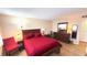 Comfortable main bedroom with wood furnishings, including large bed, dresser, and end tables at 7700 Sun Island S Dr # 506, South Pasadena, FL 33707