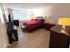 Bright main bedroom with wood furnishings, including large bed, dresser, and end tables at 7700 Sun Island S Dr # 506, South Pasadena, FL 33707