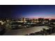 Sunset community view with condo buildings, pool, parking, and palm trees against the evening sky at 7700 Sun Island S Dr # 506, South Pasadena, FL 33707