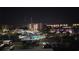 Night aerial view of several buildings, pool, parking lot and vehicles below a night sky at 7700 Sun Island S Dr # 506, South Pasadena, FL 33707