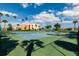 Beautifully maintained tennis court surrounded by lush greenery and open sky at 7700 Sun Island S Dr # 506, South Pasadena, FL 33707