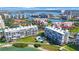 Aerial view showcases the complex with lush landscaping, pool, and picturesque waterfront location at 7872 Sailboat Key S Blvd # 602, South Pasadena, FL 33707