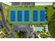 Enjoy an aerial view of the 6 tennis courts, shuffleboard and EV charging area within the community at 7872 Sailboat Key S Blvd # 602, South Pasadena, FL 33707