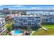 Aerial view of condos with pool, waterfront location, and city skyline in the distance at 7872 Sailboat Key S Blvd # 602, South Pasadena, FL 33707