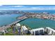 An impressive aerial view highlights the waterfront condos near a bridge, with water and beaches nearby at 7872 Sailboat Key S Blvd # 602, South Pasadena, FL 33707