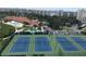 Enjoy an aerial view of the tennis courts, pools and condo buildings within the community at 7872 Sailboat Key S Blvd # 602, South Pasadena, FL 33707
