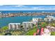 Aerial view of waterfront condos, showcasing waterfront location with lush landscaping and beach access at 7872 Sailboat Key S Blvd # 602, South Pasadena, FL 33707