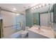 Bathroom featuring a shower/tub combo with sliding glass door, and large mirror at 7872 Sailboat Key S Blvd # 602, South Pasadena, FL 33707