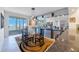 Bright dining room featuring modern lighting, a glass table, and sliding glass doors leading to a balcony with water views at 7872 Sailboat Key S Blvd # 602, South Pasadena, FL 33707