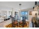 Dining room featuring a glass table, comfortable chairs, and access to an outdoor balcony at 7872 Sailboat Key S Blvd # 602, South Pasadena, FL 33707