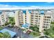 Multi-story condominium featuring a well-kept lawn, tropical landscaping, and ample parking at 7872 Sailboat Key S Blvd # 602, South Pasadena, FL 33707