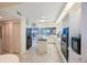 Modern white kitchen with granite island, stainless steel appliances, and beautiful view to living space at 7872 Sailboat Key S Blvd # 602, South Pasadena, FL 33707