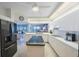 Bright, modern kitchen features white cabinetry, a center island, and stainless steel appliances at 7872 Sailboat Key S Blvd # 602, South Pasadena, FL 33707