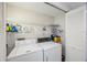 Functional laundry room with washer, dryer, wire shelving, and a storage closet for laundry essentials at 7872 Sailboat Key S Blvd # 602, South Pasadena, FL 33707