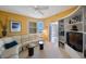Bright living room featuring white leather seating, ceiling fan, and built-in shelving at 7872 Sailboat Key S Blvd # 602, South Pasadena, FL 33707
