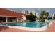 Enjoy the community's sparkling swimming pool on a sunny day surrounded by palm trees and lounge chairs at 7872 Sailboat Key S Blvd # 602, South Pasadena, FL 33707