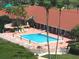 Aerial view of the community pool with surrounding lounge area and lush tropical landscaping at 7872 Sailboat Key S Blvd # 602, South Pasadena, FL 33707