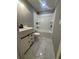 Bright bathroom offers modern white vanity, black hardware, and a combined tub/shower with upgraded fixtures and marble flooring at 816 Drane Nw St, Plant City, FL 33563