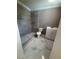 Modern bathroom features a sleek, tiled walk-in shower, updated fixtures, and contemporary marble flooring at 816 Drane Nw St, Plant City, FL 33563