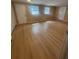 Bright and airy bedroom featuring two windows, wood floors, and two closets at 816 Drane Nw St, Plant City, FL 33563