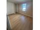Cozy bedroom featuring wood floors, bright natural light, and a closet at 816 Drane Nw St, Plant City, FL 33563