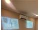 Bedroom featuring an air conditioning unit, two windows, and a neutral paint scheme at 816 Drane Nw St, Plant City, FL 33563