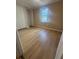 Cozy bedroom featuring wood floors, neutral walls, and a closet with a window at 816 Drane Nw St, Plant City, FL 33563