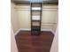 Empty closet with a wooden shelving system on a dark wood floor at 816 Drane Nw St, Plant City, FL 33563