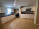 Bright kitchen features white cabinets, mosaic backsplash, stainless-steel appliances, and modern countertops at 816 Drane Nw St, Plant City, FL 33563